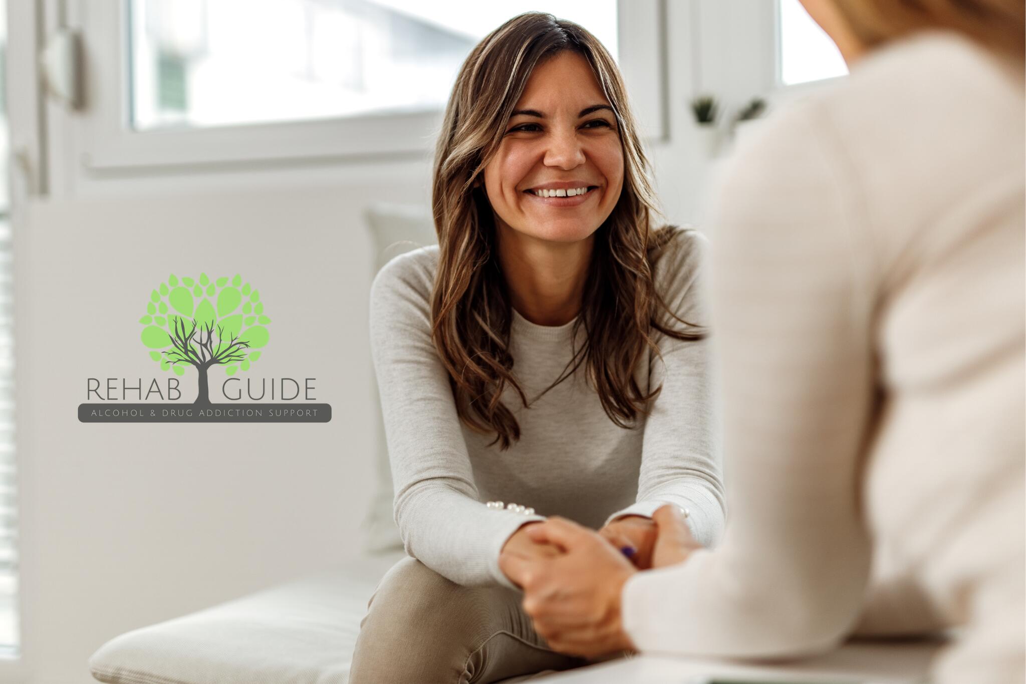 A woman talking to an addiction counsellor in a bright, modern room