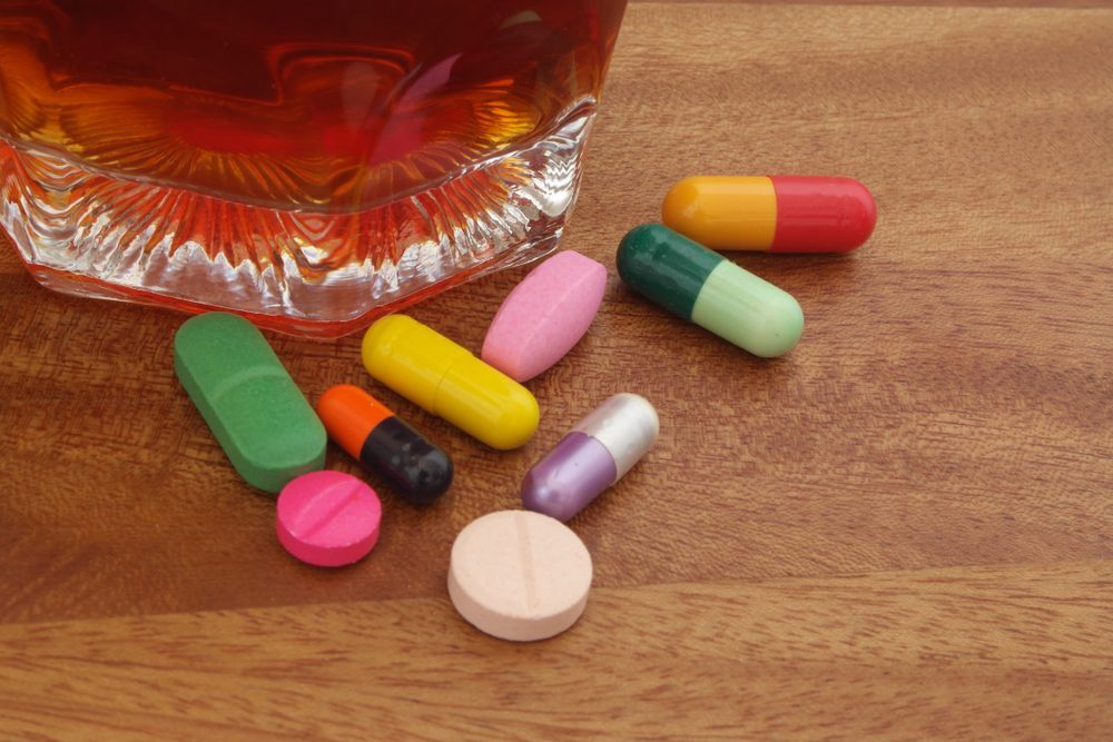 Overcoming Alcohol Addiction: Steps to Recovery Pills and alcohol on table representing addiction recovery journey