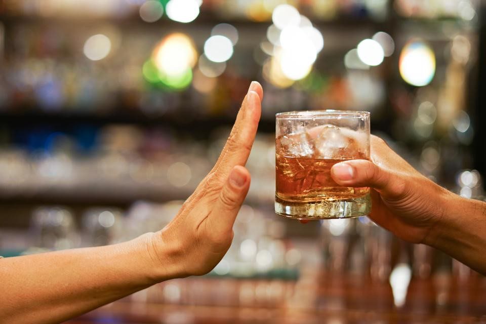 Alcohol Allergy Symptoms: Understanding and Avoiding Risks Person refusing a drink, illustrating alcohol allergy symptoms