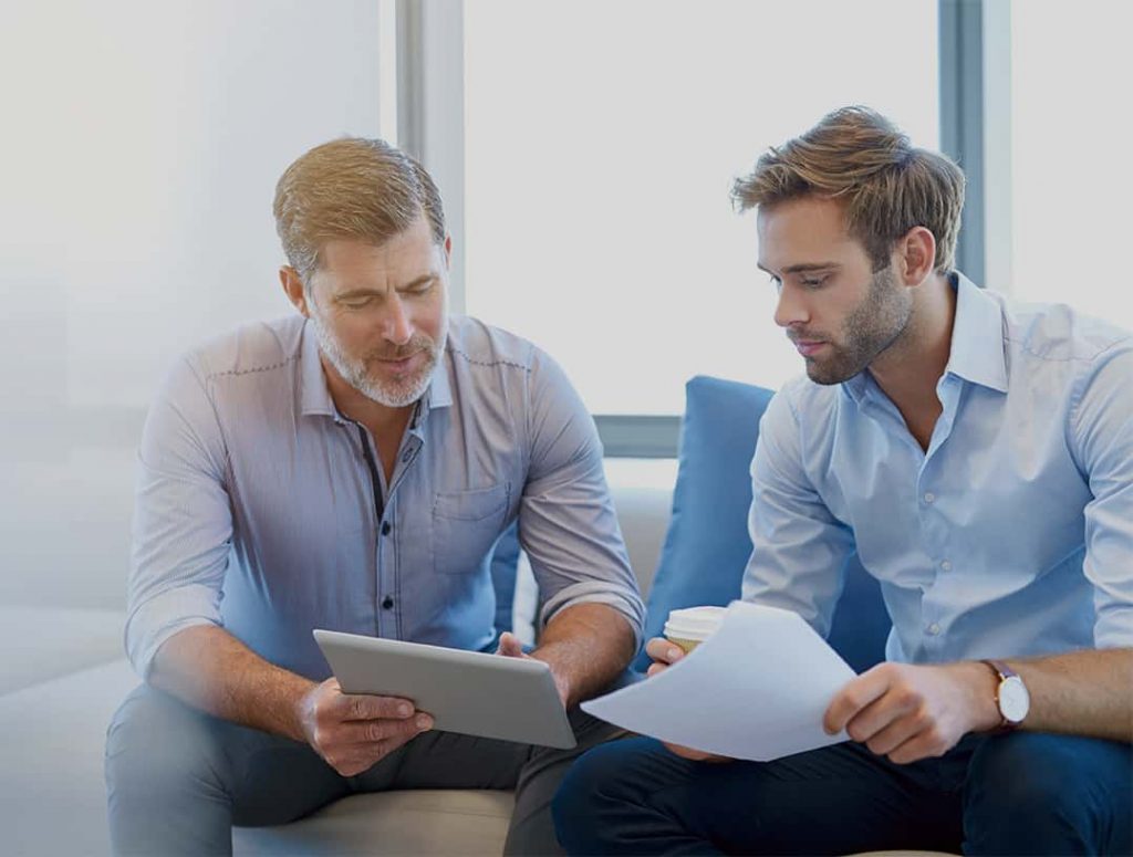 Collaborative Support in Alcohol Recovery Journey Two men discussing alcohol recovery plans in a supportive setting.