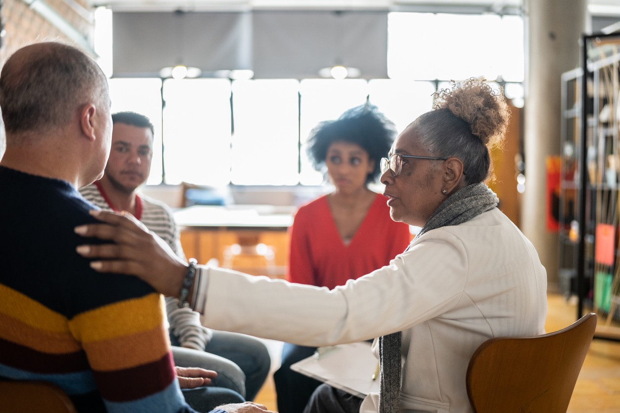 Supportive Group Therapy for Alcohol Recovery Support group discussing alcohol recovery in a therapy session