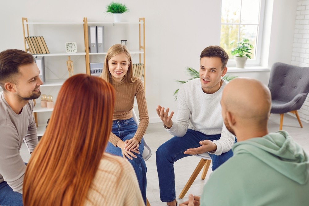 Group discussing dialectical behavioural therapy in rehab setting