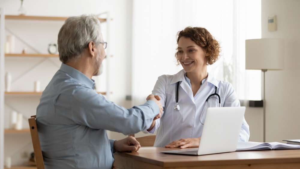 Friendly Doctor Supports Alcohol Recovery Journey Doctor and patient handshake, addiction recovery consultation