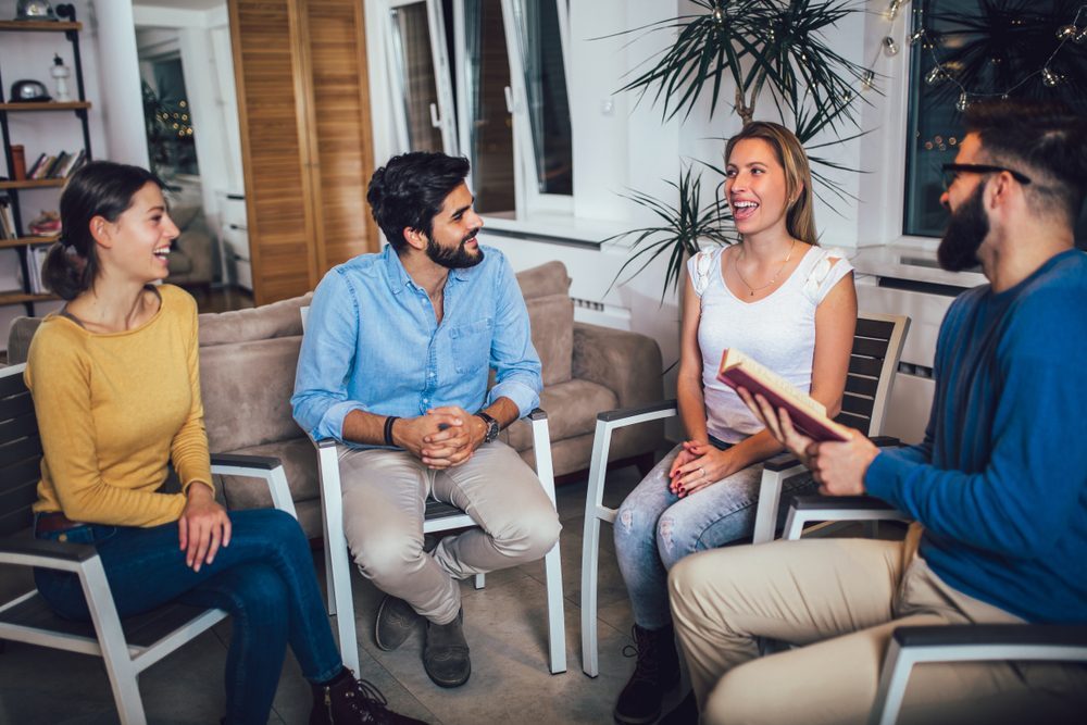 Group Therapy Session for Alcohol Recovery Support Group of people in a therapy session discussing alcohol recovery