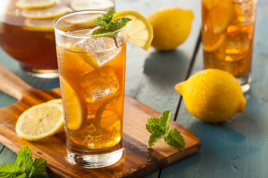 Non Alcoholic Beer: Refreshing Lemon Tea Alternative Iced lemon tea on a board with lemon wedges and mint, non alcoholic