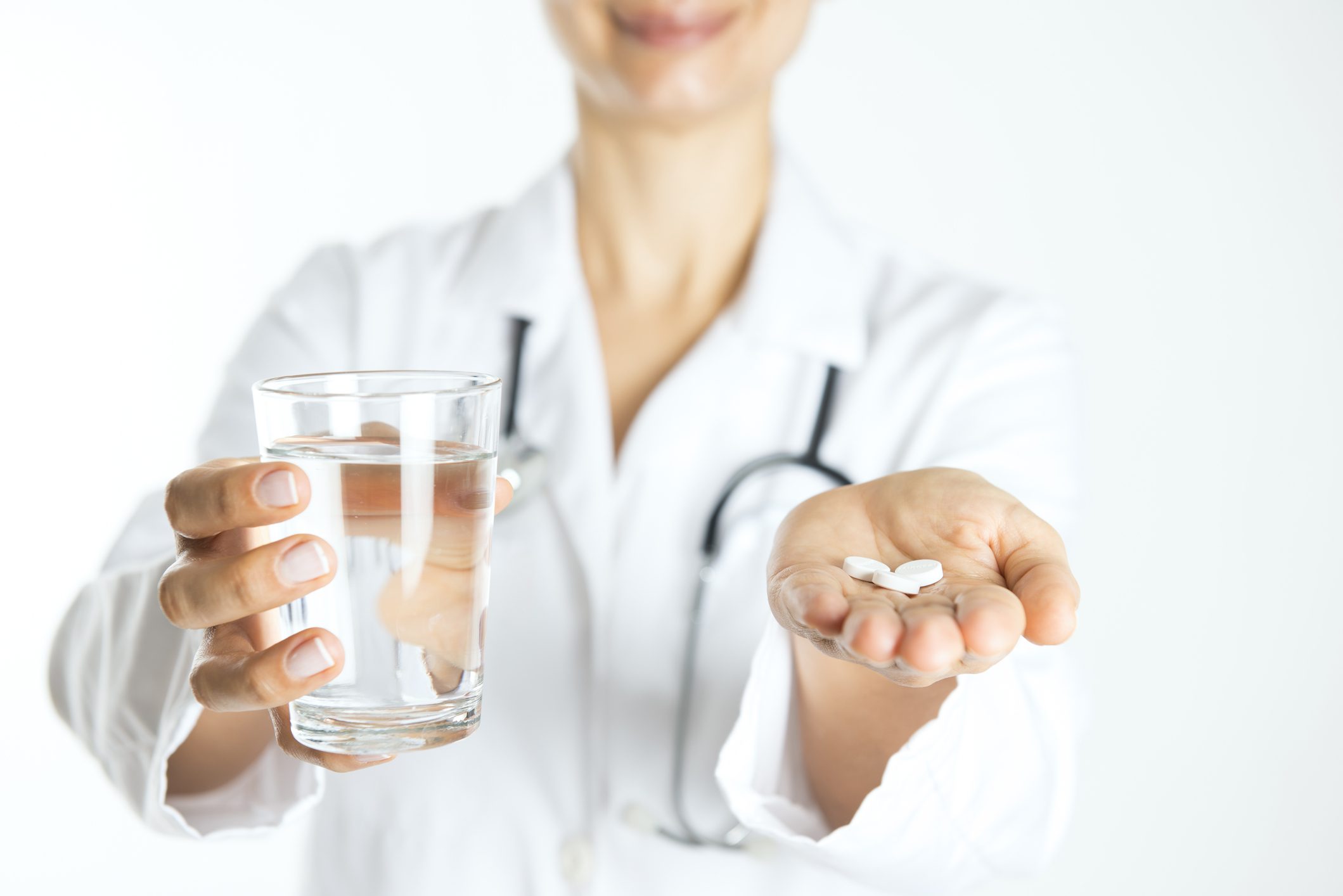 Pregabalin and Alcohol: What You Need to Know for Recovery Doctor holding Pregabalin pills and glass of water for alcohol recovery