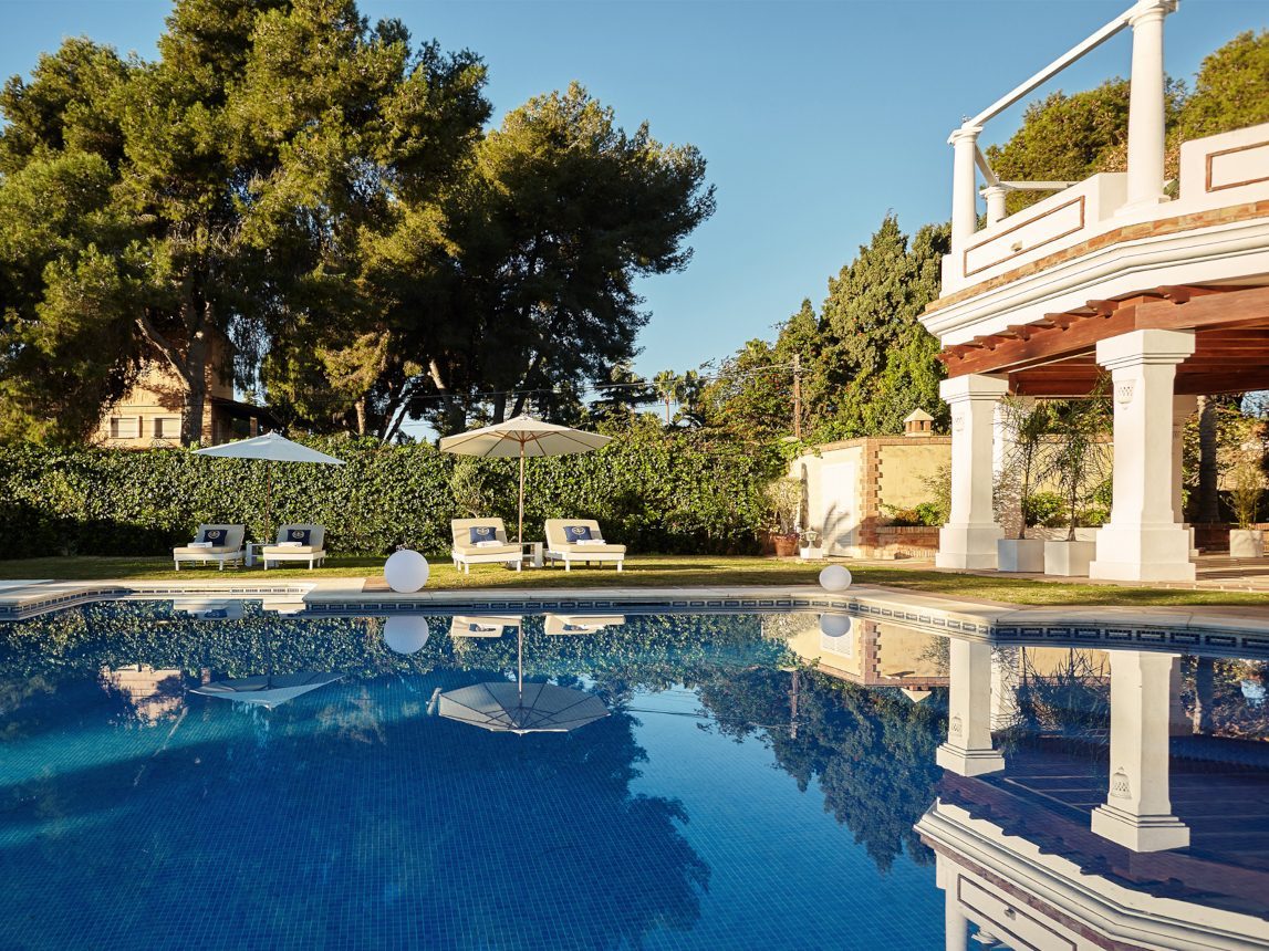 Tranquil Rehab Poolside Retreat for Alcohol Recovery Serene poolside at a rehab center for alcohol recovery with lounge chairs