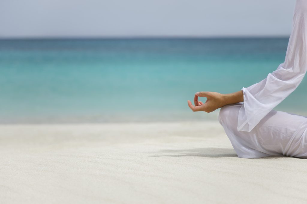 Yoga and Meditation on Beach for Rehab Spain Recovery Person meditating on a beach for Rehab Spain alcohol recovery