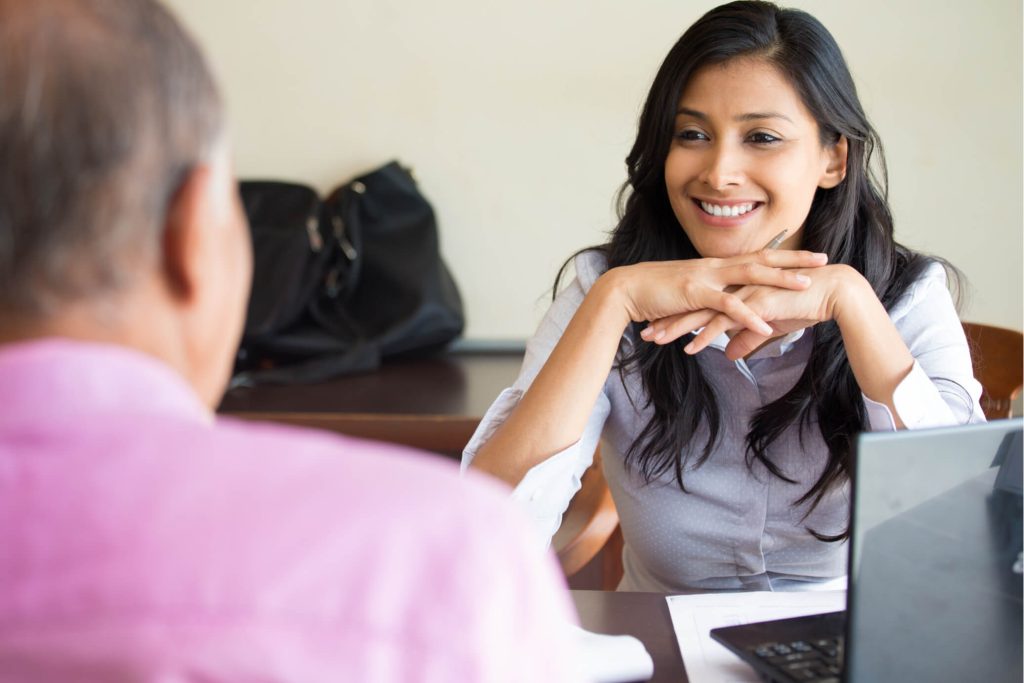 Smiling Counselor Assisting in Alcohol Recovery Woman counselor smiling during alcohol recovery consultation