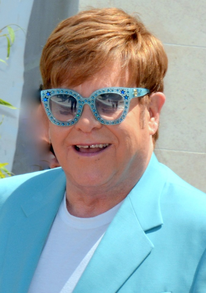 Sober celebrities: Famous figure in bright outfit smiling outdoors