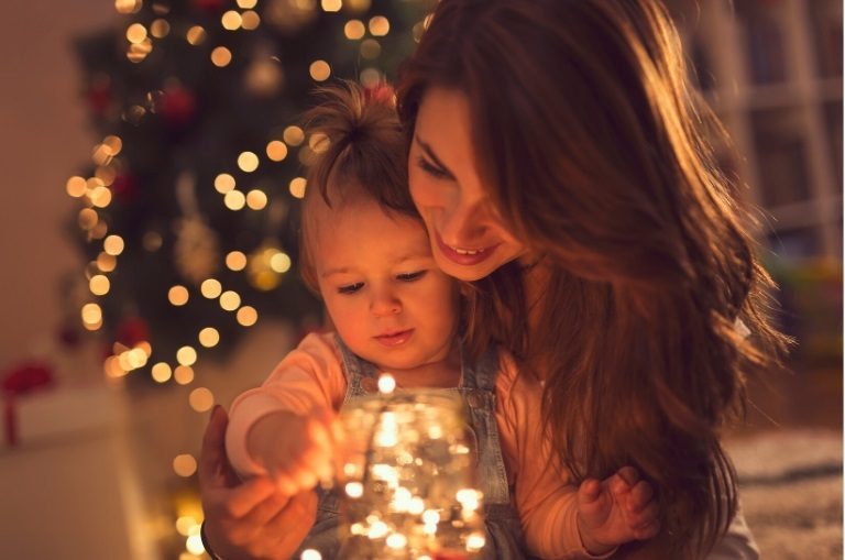 Sober Christmas: Finding Joy and Connection in Sobriety Mother and child enjoying a sober Christmas with festive lights.