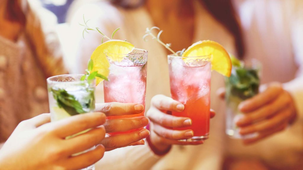 Sober for October: Celebrate with Alcohol-Free Drinks Hands holding alcohol-free drinks to celebrate sober for October