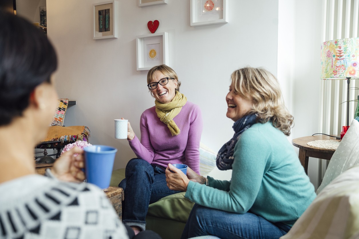Supportive Group Chat in Alcohol Recovery Program Three women enjoying a supportive conversation over coffee
