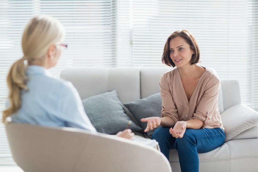 Therapy Session for Alcohol Recovery Support Woman in counseling session discussing alcohol rehab support