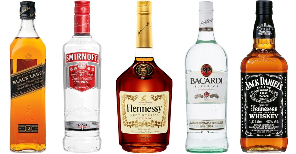 Types of Alcohol: Understanding Common Liquor Varieties Bottles of various types of alcohol including whiskey, vodka, cognac, and rum.
